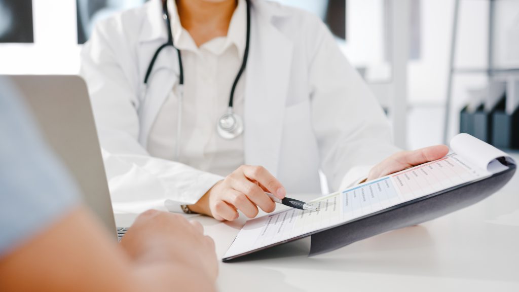 Young Asia Female Doctor In White Medical Uniform Using Clipboar