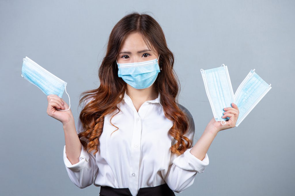 Portrait Of Young Beautiful Business Woman Wearing Face Mask On